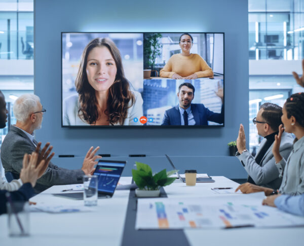 Video Conference Call in Office Boardroom Meeting Room: Executive Directors Talk with Group of Multi-Ethnic Entrepreneurs, Managers, Investors. Businesspeople Discuss e-Commerce Investment Strategy