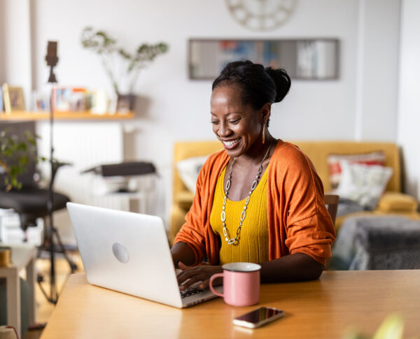 Mature woman working on laptop at home